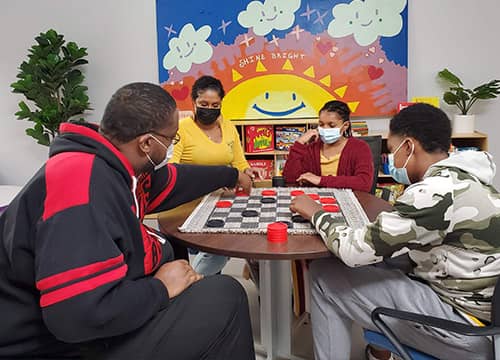family playing checkers together