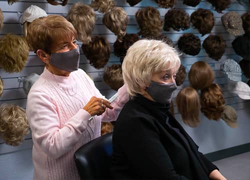 participant being fitted for a wig